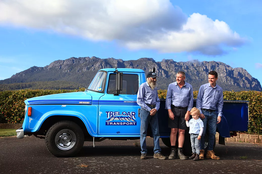 Photo of Treloar team and kid in front of blue ute